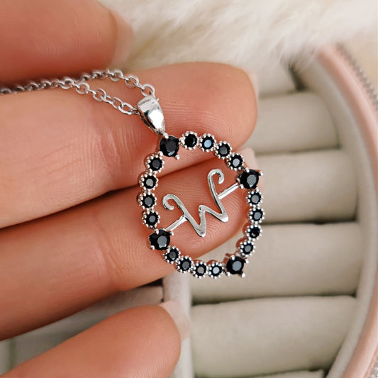 Magical talisman necklace with rotating initial