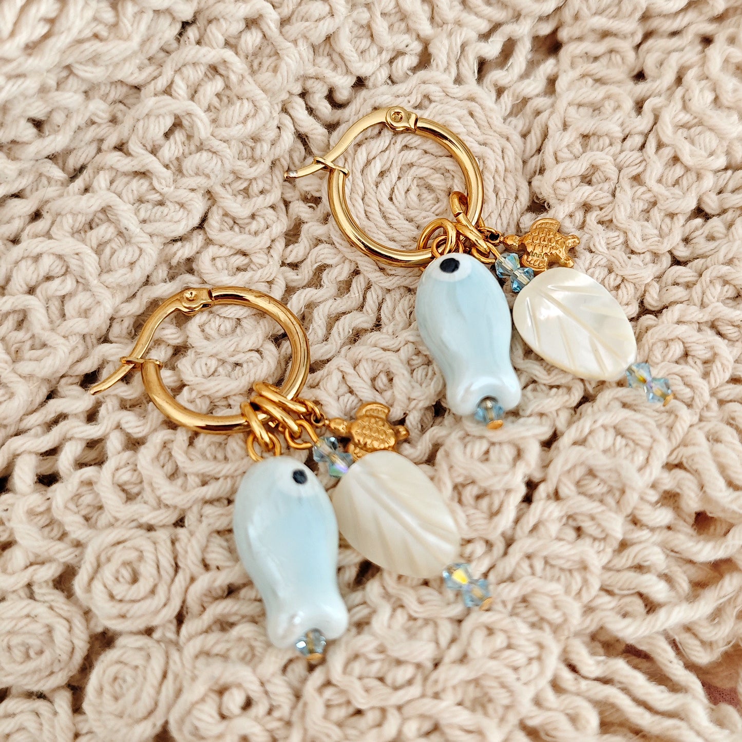 "Coastal Aura" earrings with ceramic fish, mother-of-pearl leaves, and turtles
