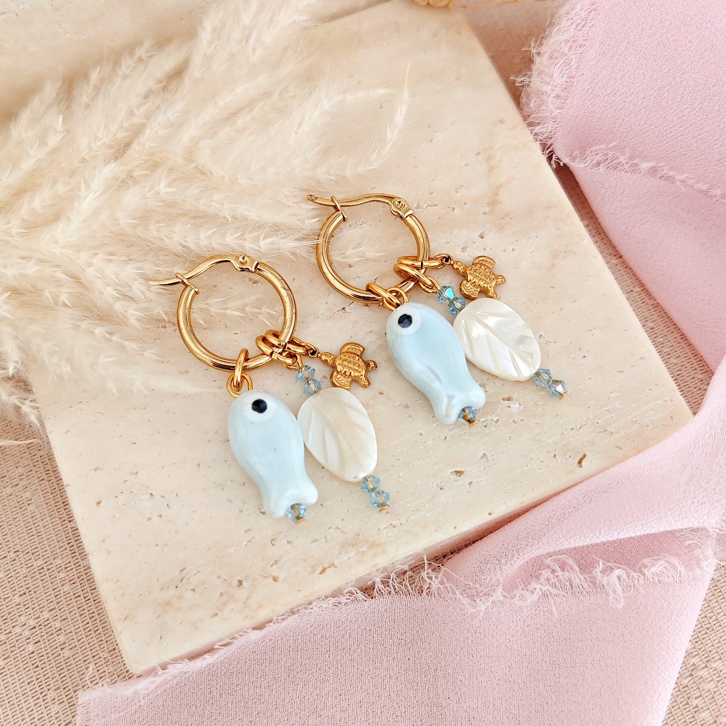 "Coastal Aura" earrings with ceramic fish, mother-of-pearl leaves, and turtles