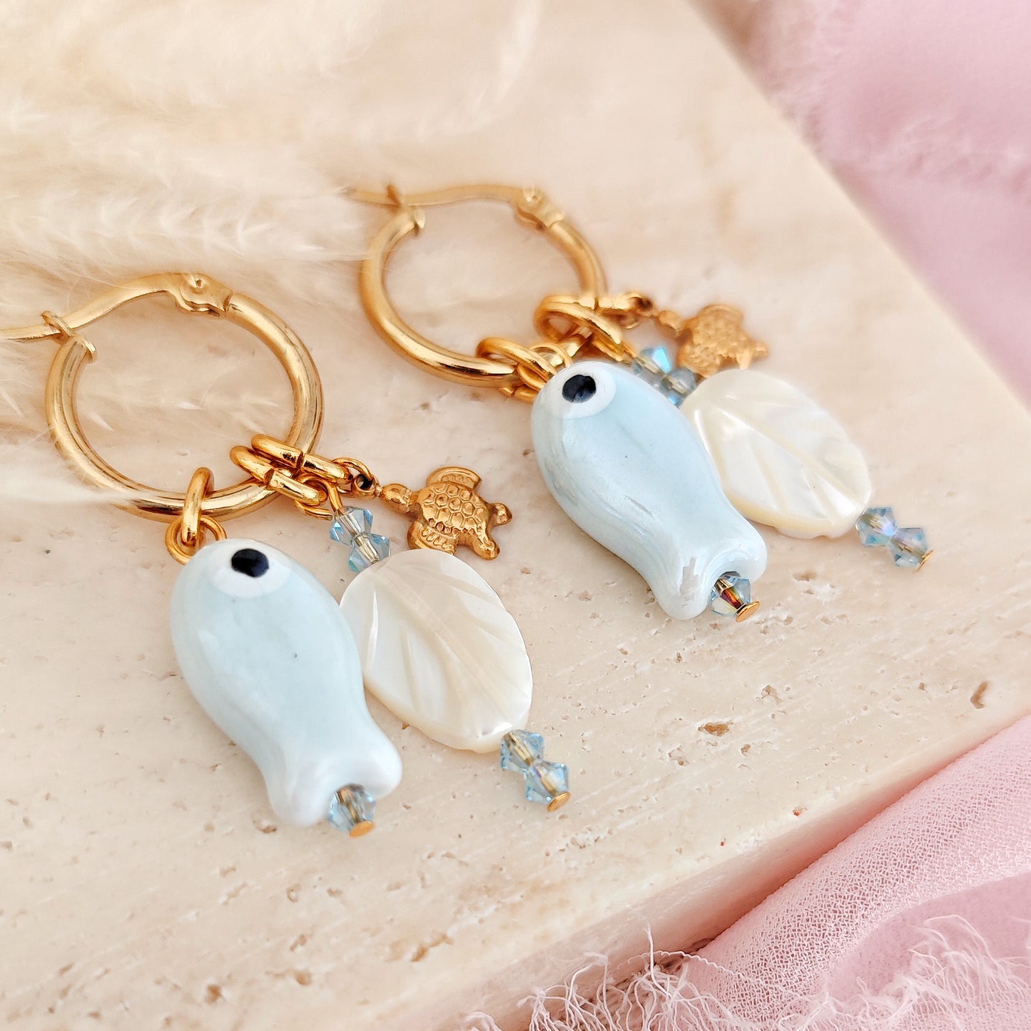 "Coastal Aura" earrings with ceramic fish, mother-of-pearl leaves, and turtles