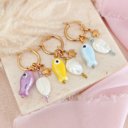 "Coastal Aura" earrings with ceramic fish, mother-of-pearl leaves, and turtles